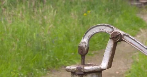 Handle of a water pump moving up and down, pumping water Stock Footage 65451330