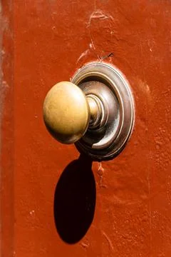 Handle On A Weathered Red Door Foto stock