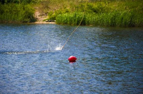 The handle that you hold while riding a wakeboard jumps on the water Stock Photos