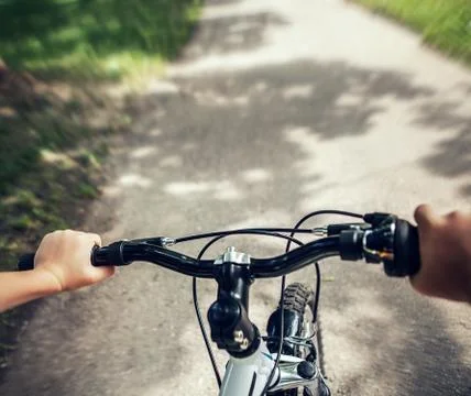 Handlebar with child hands close up image Stock Photos