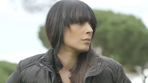 Handled shot of a sad pensive and depressed woman outdoor in a park  Stock Footage 70868761