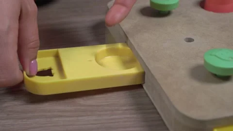 Handler with pink manicure hides dried treat in secret compartment of complex Stock Footage 151658280