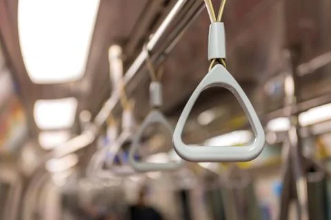Handles on ceiling for standing passenger inside a bus Stock Photos