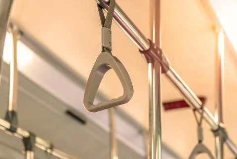 Handles on ceiling for standing passenger inside a bus Stock Photos