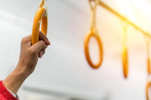 Handles on ceiling for standing passenger inside a bus Stock Photos