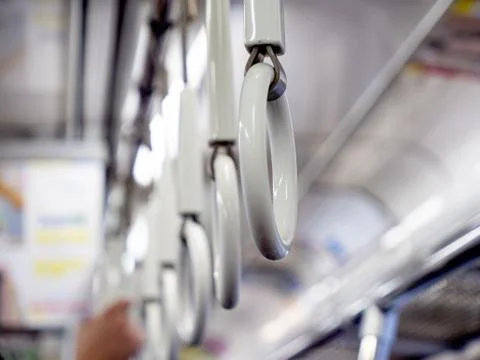 Handles on an empty commuter or underground train Foto stock