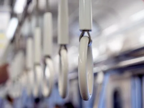 Handles on an empty commuter or underground train Stock Photos