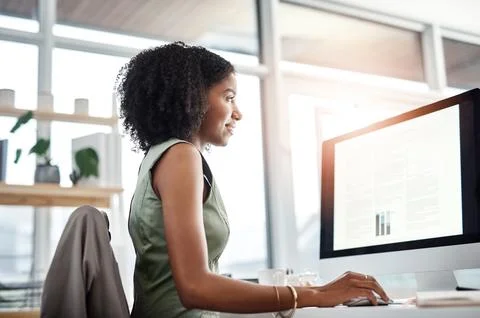 Handling her workload with ease. a young businesswoman working at her desk in a Stock Photos