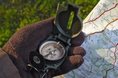 Handling a military compass and map Stock Photos