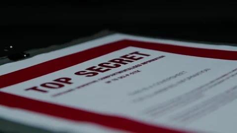 Handling a Paper Folder with a 'Top Secret' Cover Page Stock Footage 327398538