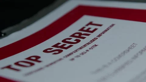 Handling a Paper Folder with a 'Top Secret' Cover Page Stock Footage 327398552