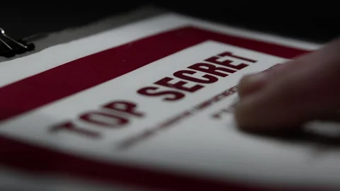Handling a Paper Folder with a 'Top Secret' Cover Page Stock Footage 327398772