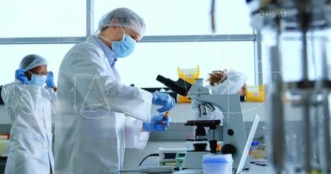 Handling scientist preparing samples at lab bench, wearing white lab coat, using Stock Photos