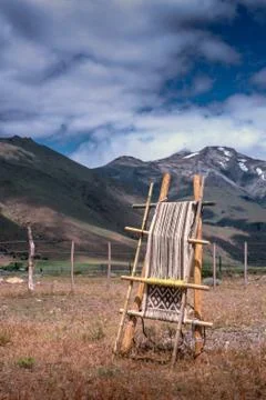 A handloom is a simple machine used for weaving. In a wooden vertical-shaft l Stock Photos