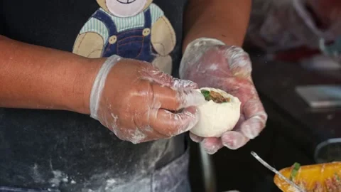 Handmade authentic Xian Bing meat pie, a stall vendor filling a dough Stock Footage 274244489