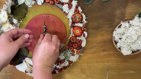 Handmade autumn clock decorated with dried flowers and pumpkins. Cozy fall craft Stock Footage 317582380