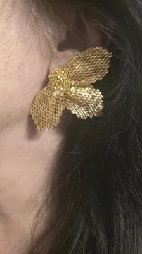 Handmade beaded and bugle bead earrings on a girl's ear. Product demonstratio Stock-Fotos