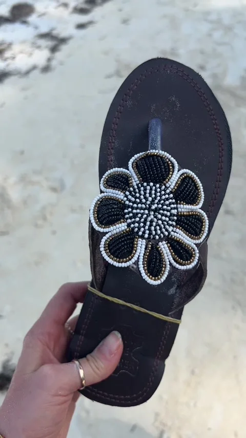 Handmade beaded leather flip flop sandal African craft Zanzibar HD vertical Stock Footage 342148241