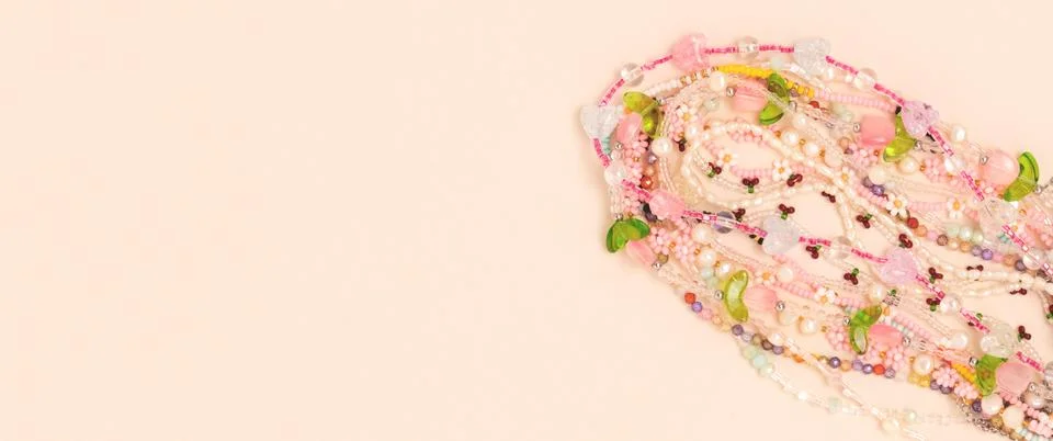 Handmade beads on a beige background. Stock Photos