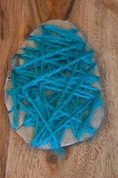 Handmade blue yarn Easter egg decoration Stock Photos