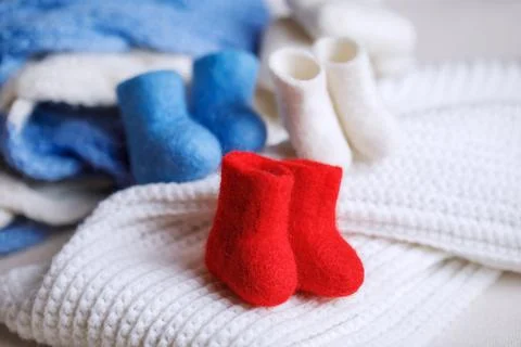 Handmade boots made of wool in red, white and blue colors. Stock Photos