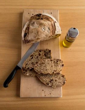 Handmade bread just cut closed to an oil bottle Stock Photos