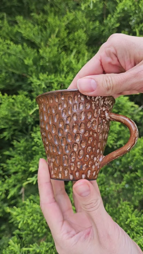 Handmade Brown Ceramic Mug with Carved Texture Video stock 324714440