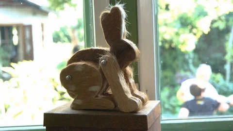 Handmade bunny on box next to window Stock Footage 114011463