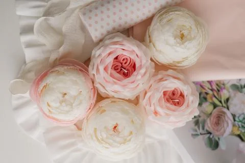 Handmade candle in the shape of a flower on a light background, space for text Stock Photos