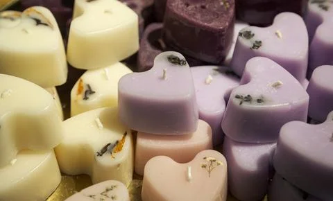 Handmade candles in the shape of hearts, close-up, workshop concept. Stock Photos