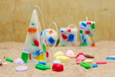 Handmade candles in the shape of a pyramid, cube, cylinder and sphere Stock Photos