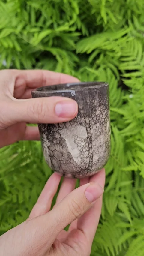 Handmade Ceramic Cup With Bubble Texture Rotated in Hands Video stock 324531487