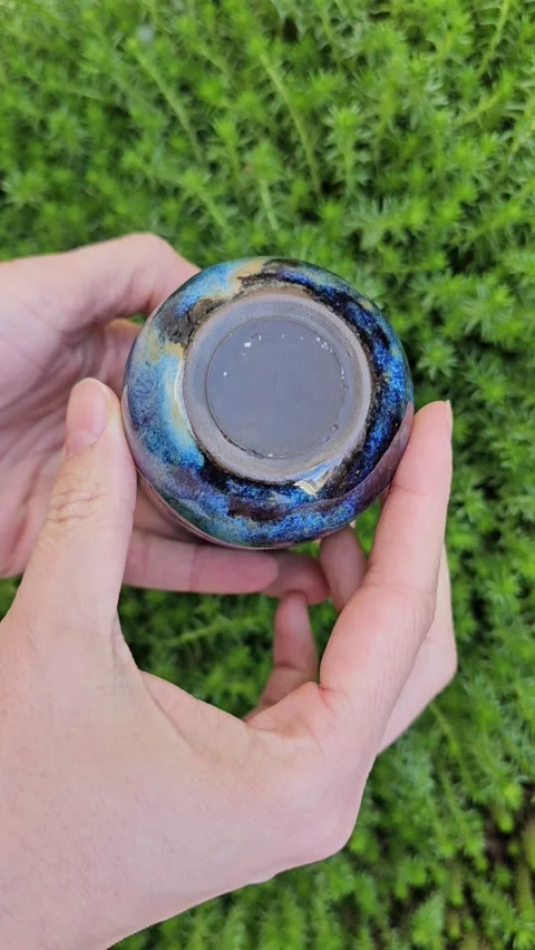 Handmade ceramic cup with multicolor flowing glaze Video stock 324531872