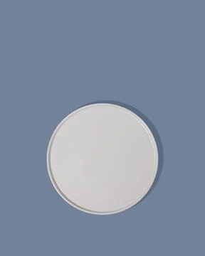 Handmade ceramic, empty craft ceramic plate on blue background top view Stock Photos