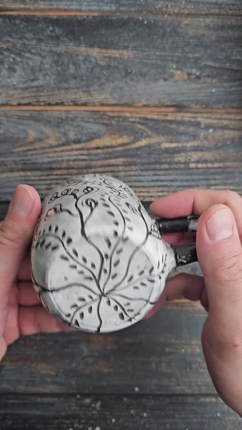 Handmade ceramic mug with sgraffito botanical pattern Video stock 325001681