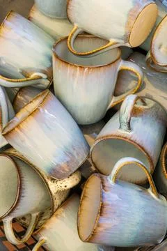 Handmade ceramic mugs stacks background Stock Photos