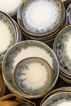 Handmade ceramic plate stacks background Stock Photos