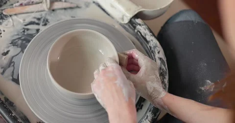 Handmade ceramics concept. Close-up of woman's hands in pottery studio. Top view Stock Footage 155992856