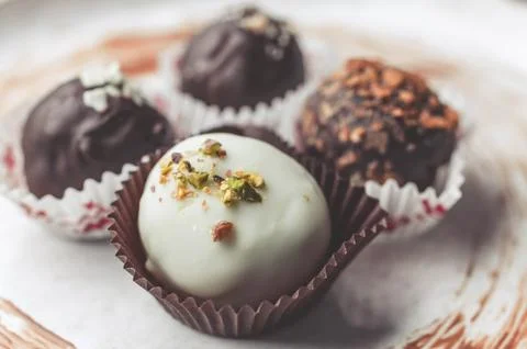 Handmade chocolates with cheese stuffing. white and classical dark chocolate Stock Photos