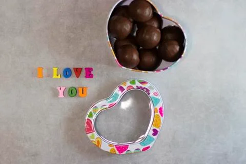 Handmade chocolates in a metal box in the shape of a heart Valentine's Day Co Stock Photos