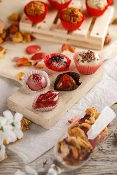 Handmade chocolates on a white wooden background Stock Photos