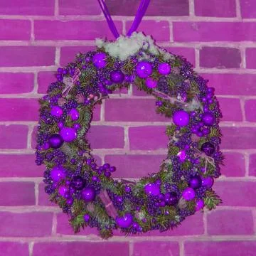 Handmade Christmas wreath on a red brick wall background. Festive decoration of Stock Photos