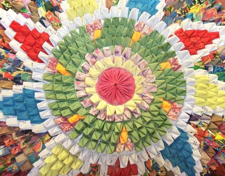Handmade circular rug with floral pattern in patchwork style Stock Photos