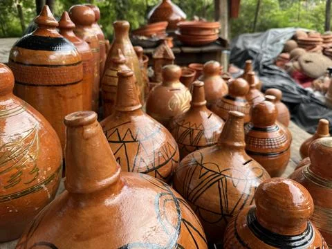 Handmade clay earthenware pots with painted designs are displayed outdoors at 스톡 사진