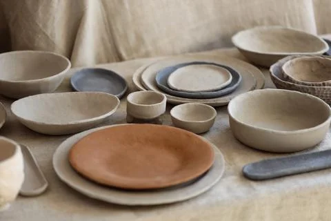 Handmade Clay Tableware Set on Fabric Stock Photos