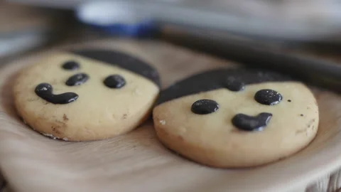 Handmade cookie, human face cookie, wooden round plate Stock Footage 186878763