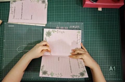 Handmade creating of the diary from special scrapbooking paper Stock Photos