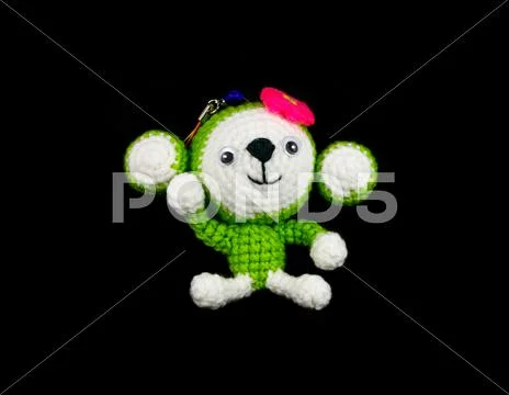 Handmade crochet monkey doll on black background Stock Photos