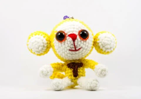 Handmade crochet monkey doll on white background Stock Photos