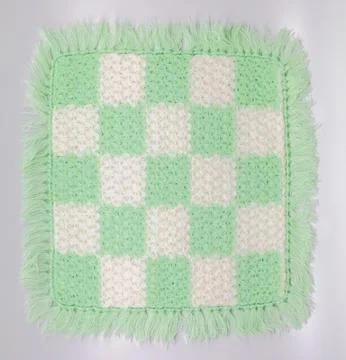 Handmade Crocheted Checkered Mat in Light Green and White with Fringe Stock Photos